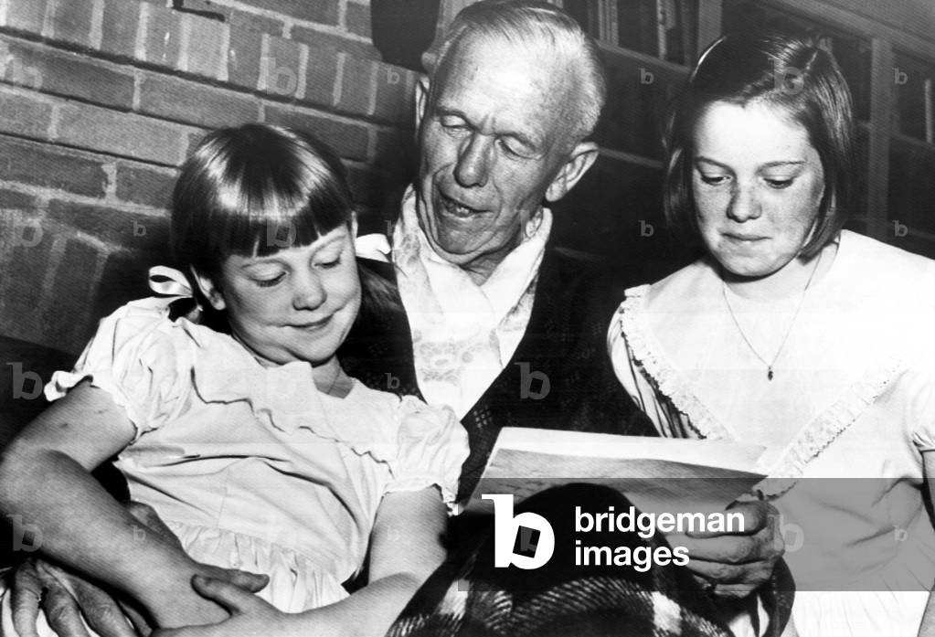 General George C. Marshall (center), reading telegrams to his granddaughters Ellene (left), and Katherine (far right), North Carolina, October 31, 1953.