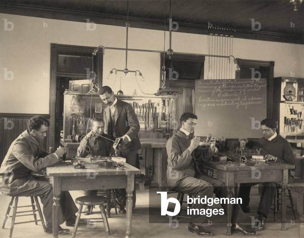 Students constructing telephones at Hampton Institute. African American higher education stressed practical skills and services, to counter employment discrimination for blacks. c. 1899