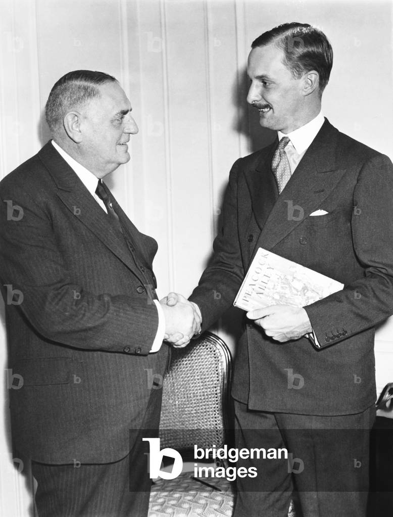 Waldorf Astor, 2nd Viscount Astor (1879-1952) (right), grandson of William Waldorf Astor in New York, Oct 23, 1933. He is welcomed to the Waldorf Astoria Hotel by Oscar Tschirky, famous maître dof the hotel