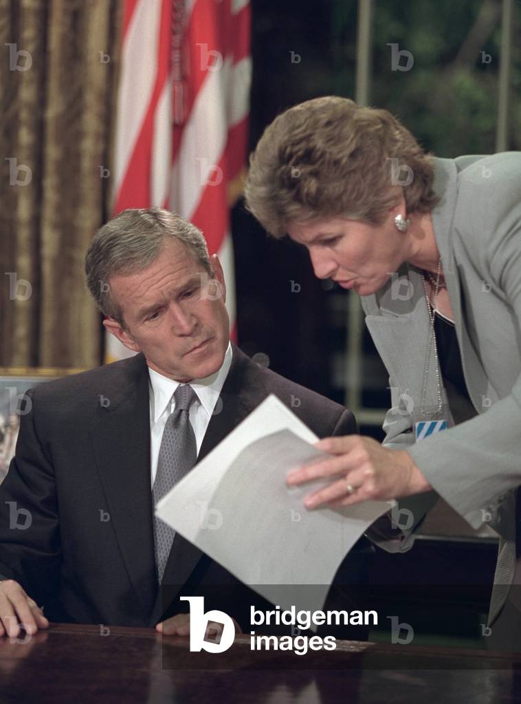 President George W. Bush reviews notes with Karen Hughes before speaking from the Oval Office. He spoke 12 hours after the 9-11 Terrorist attacks on New York City and Washington, D.C. Sept. 11, 2001