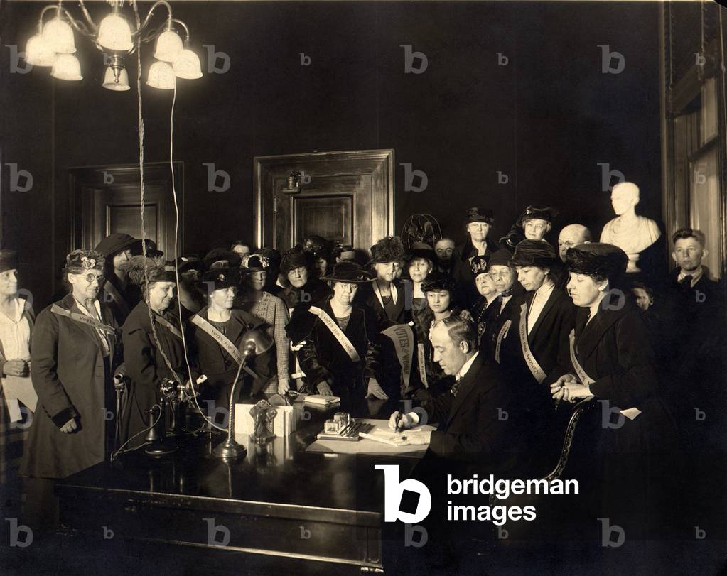 A room full women wearing Votes for Women' banners, witness Governor Edwin P. Morrow signing Kentucky's ratification of the 19th Amendment. Kentucky was the 24th state of the required 36 to ratify. January 6, 1920