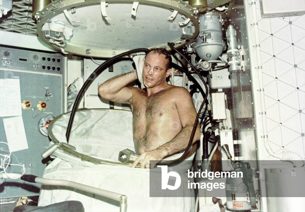 Astronaut Jack R. Lousma, taking a hot bath in the crew quarters aboard Skylab. The Skylab 3 crew conducted medical, scientific, and technological experiments during their 59 day mission from July 28 to Sept. 25, 1973