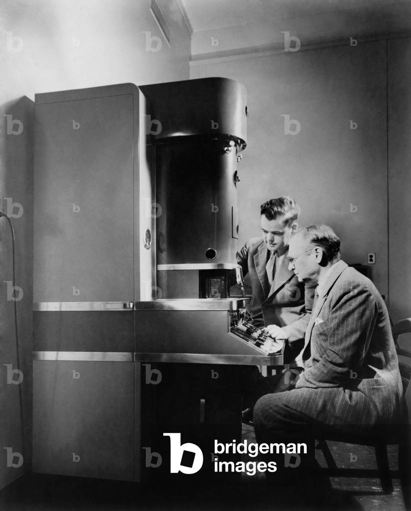 Dr. V.K. Zworykin and Dr. James Hillier of RCA Laboratories at the electron microscope. Invented in the 1930, it exceeded magnification of optical microscopes. c. 1945