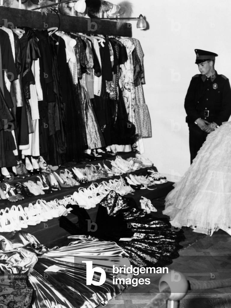 Soldier guards the late Eva Peron's luxury after the overthrow of Argentina's dictator Juan Peron. In addition to jewelry, paintings, ivory carvings and other riches, her closets held 400 dresses, 600 hats and dozens of pairs of shoes and boots. Items worth more than ,500,000 (  million in 2015) were placed on public display by the revolutionary government of President Eduardo Lonardi. Oct. 20, 1955.
