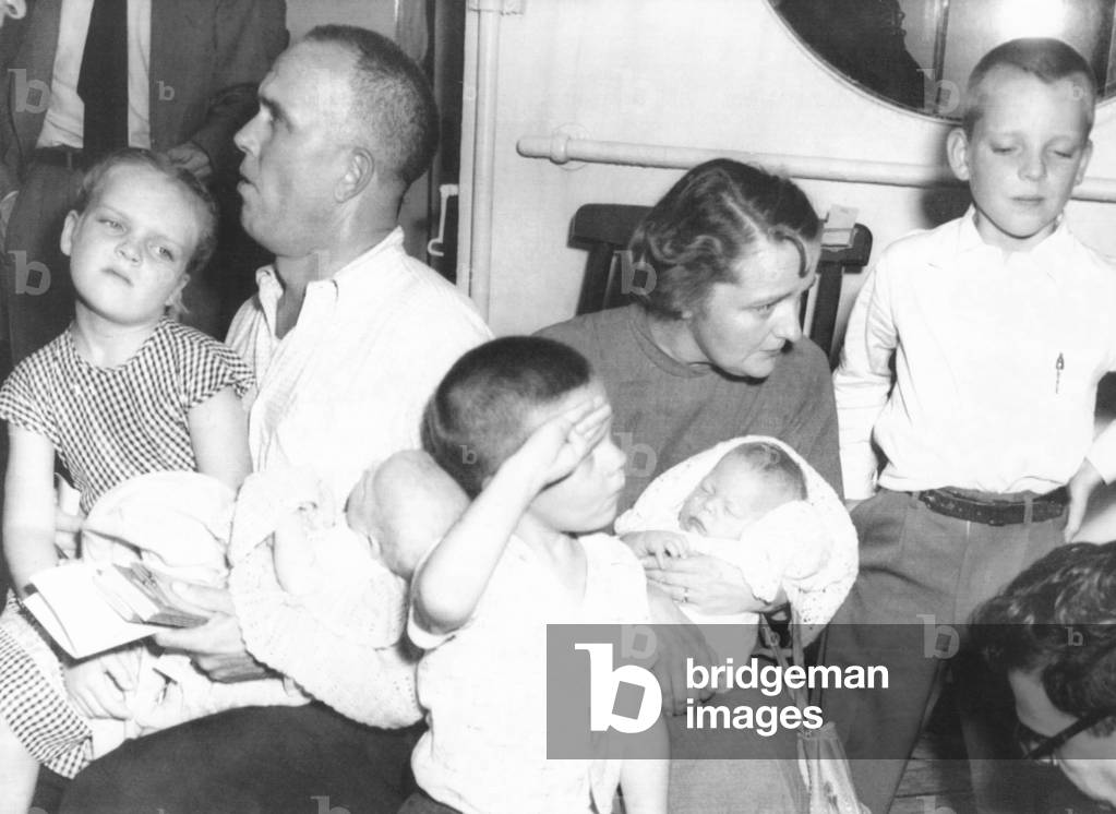 Survivors of the ill-fated Italian liner Andrea Doria, July 26, 1956. Mr. and Mrs. Ellis Hill, of Detroit, Michigan pose with their five children aboard the 'Ilda France'. The French liner took on 753 Andrea Doria passengers in a 6-hour rescue operation