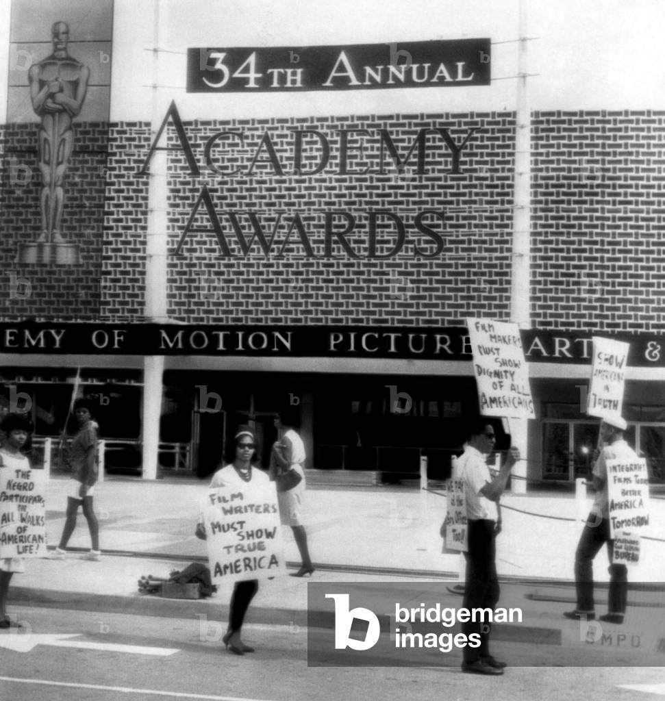 The Hollywood Race Relations Bureau protesting the asserted unrealistic portrayals of African Americans in film, march in front of the Santa Monica Civic Auditorium where the 34th annual Academy Award presentations will be made, April 7, 1962