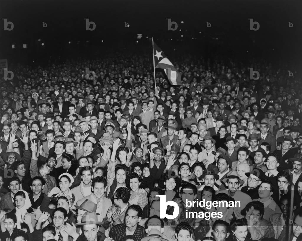 Puerto Rican crowd waits to hear former Secretary of State Henry Wallace speak in New York City. 1946. The former Vice President opposed President Harry Truman's hard line against the USSR, and advocated expansion of New Deal social programs
