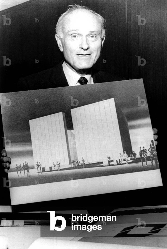 PHILIP JOHNSON holding his design for the John F. Kennedy Memorial in Dallas, Texas, 1965