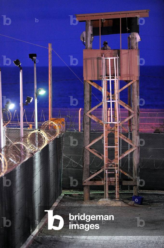 U.S. Soldier stands watch in a guard tower at Camp Delta in Guantanamo Bay Naval Base Cuba. July 7 2010., Photo by:Everett Collection