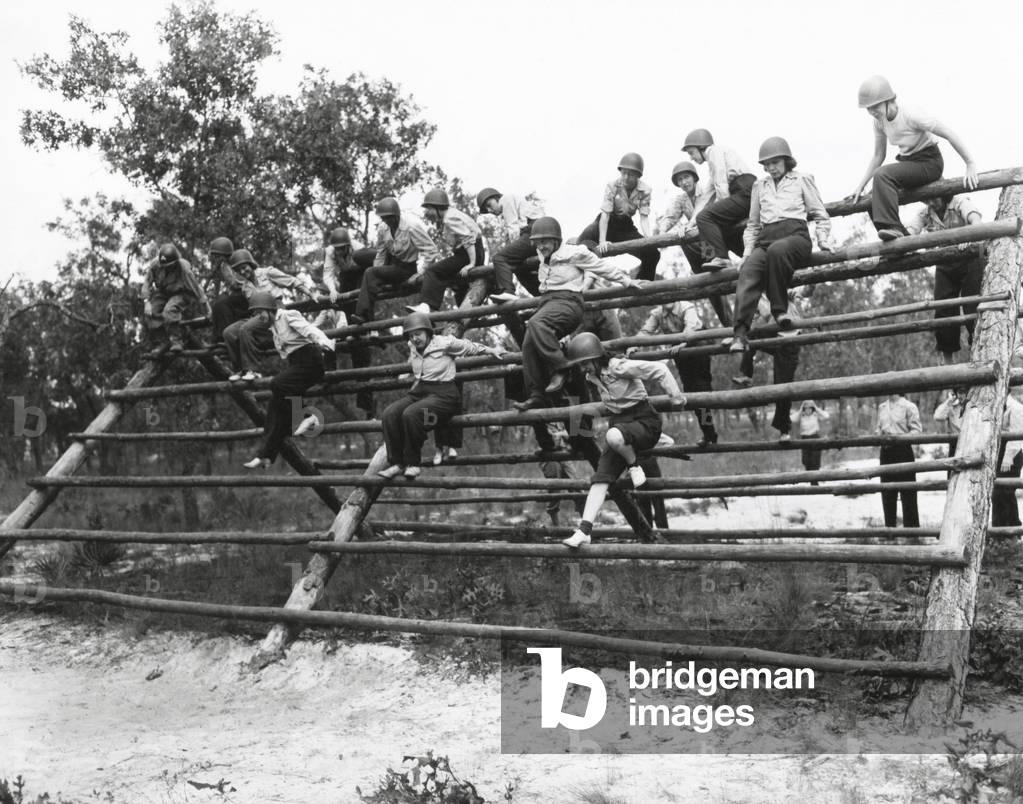 U.S. Women's Army Corps nurses in basic training. The WACs climb a log ladder on the obstacle course at Camp Blanding, Fla. Oct. 1, 1943. World War 2