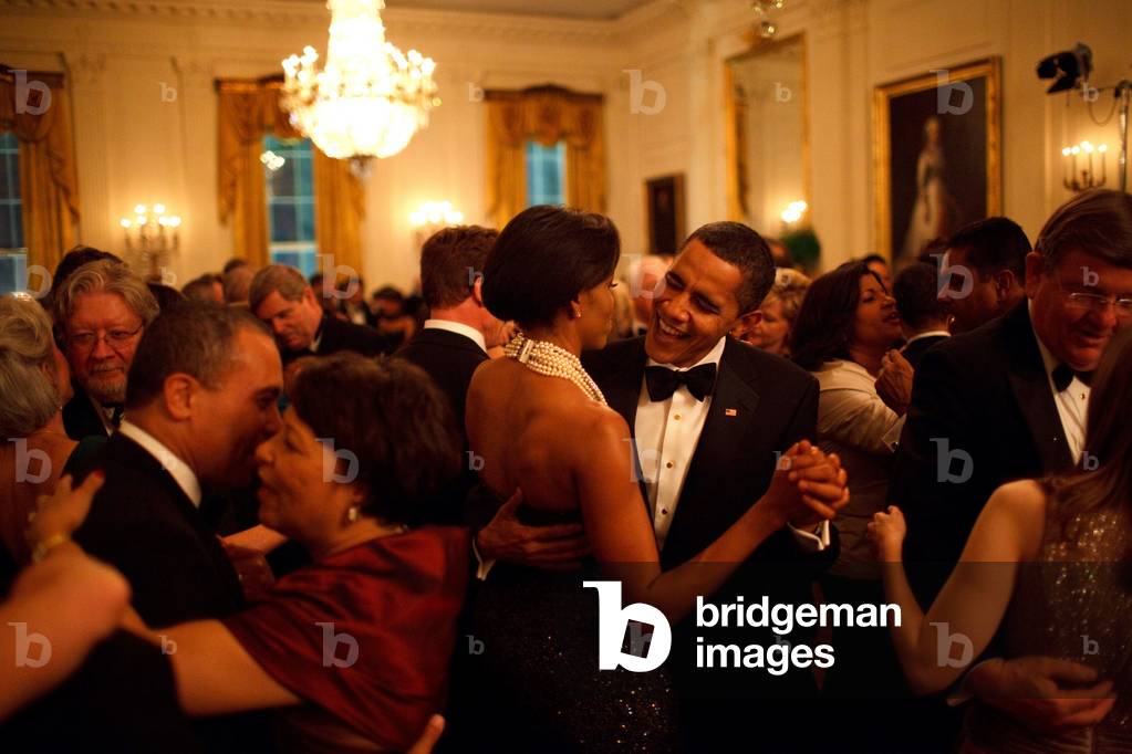 President and Michelle Obama dance to the music of 'Earth Wind and Fire' at the Governors Ball in the White House. Michelle wears a deep purple sequined strapless gown by Peter Soronen with a multi-stranded necklace of pearls and crystals by Tom Binns. Feb. 22 2009.,