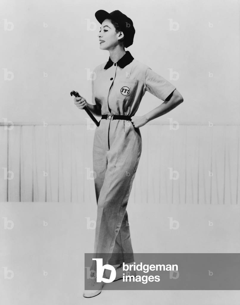 Model wearing coveralls with insignia 'FFI' (Fashion for Industry) and matching cap. 1953
