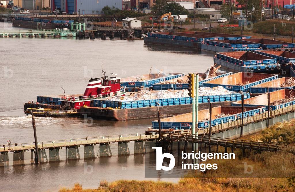 Debris from the World Trade Center arrives by barge at the landfill on Staten Island. Approximately 10 tons of debris was processed daily for victim identification and evidence related to the attack. Oct. 16 2001