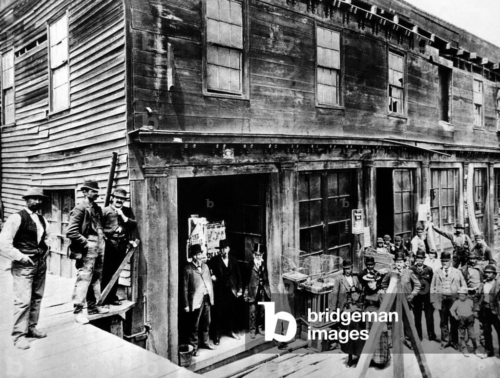 Abe Warner opened his saloon on Meigg's Wharf in 1856, and it soon was called the Cobweb Palace. He loved spiders, and allowed them for years to spin their webs. in saloon. He added nude paintings, caged monkeys, and a parrot that swore in four languages. c. 1870s