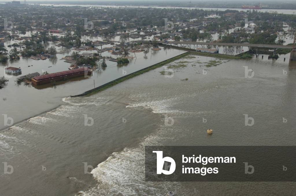 A breech in a New Orleans levee floods neighborhoods the day after the Hurricane Katrina hit the city. August 30 2005