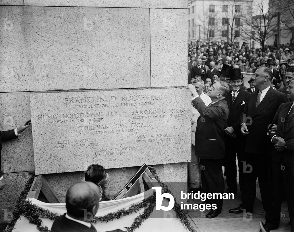 Harold Ickes, Interior Secretary, lays cornerstone of building as FDR watches. 1936. Ickes holds the trowel George Washington used for the U.S. Capitol in 1793