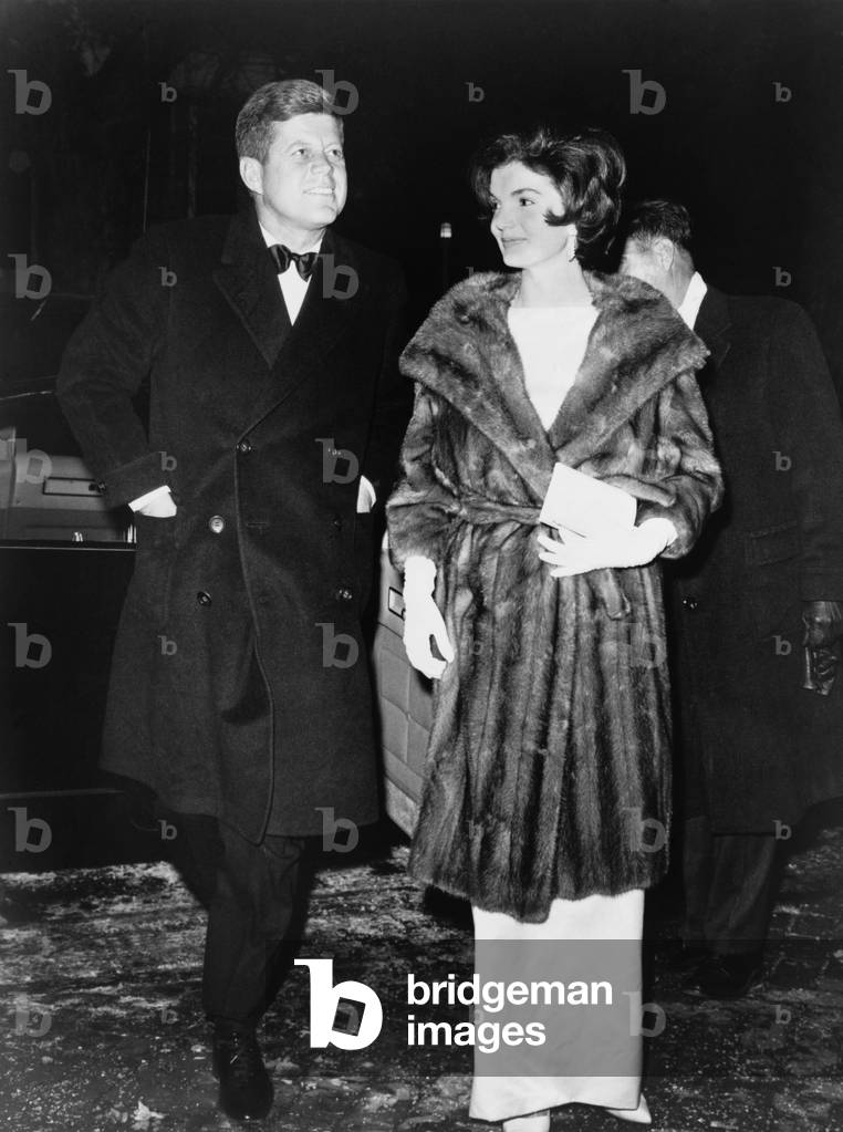 President and Mrs. Kennedy en route to a private party on March 7, 1961. On the cold winter night, Jacqueline Kennedy wears a mink coat