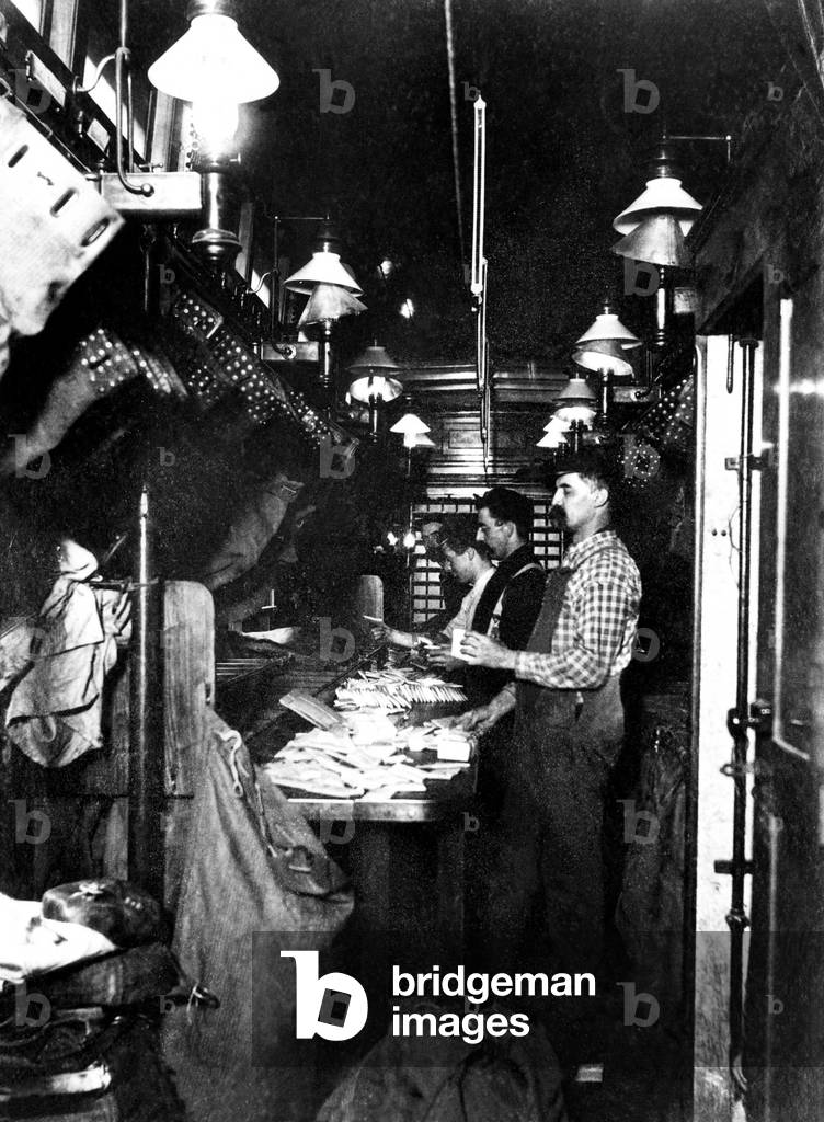 Sorting the mail in a railway post office on a mail train, 1930s.