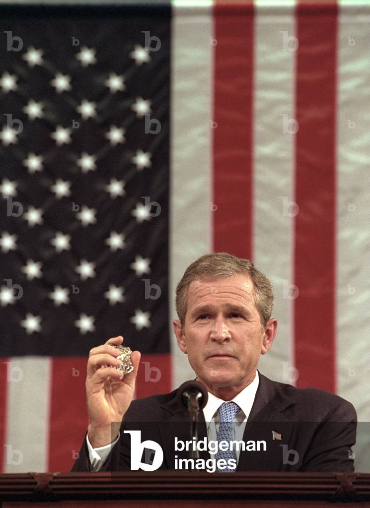 President George W. Bush holds the badge of a Port Authority Police officer killed on Sept. 11, 2001. Bush 43 said, 'I will carry this. It is the police shield of a man named George Howard who died at the World Trade Center trying to save others', during his speech to a joint session of Congress on Sept 20, 2001