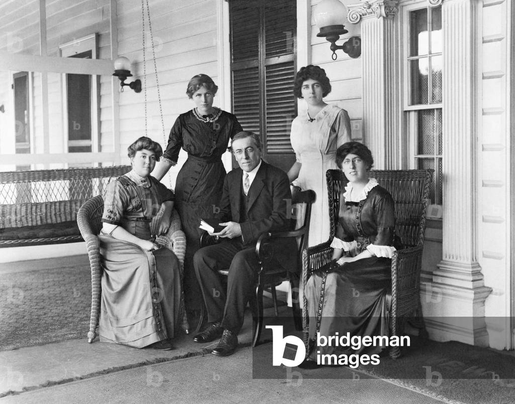 Woodrow Wilson with his first wife Ellen Louise Axson 1860-1914 and his three daughters L to R Jessie Eleanor and Margaret on the porch of Wilson's summer home in Sea Girt New Jersey in 1912. Ellen died of kidney disease in the second year of his presidency