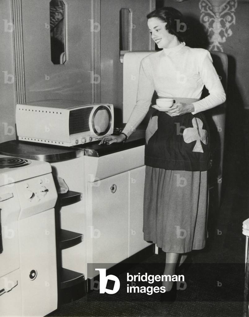 A television in the kitchen for the first broadcast of a cooking show in New York. Sept. 1949.