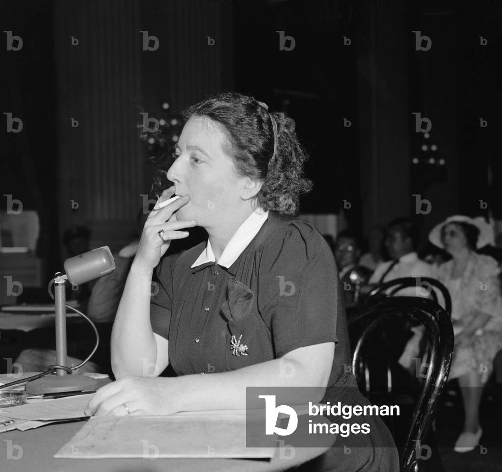 Hazel Huffman, testifying against the WPA Theater Project. As a WPA mail room clerk she snitched to the Red-baiting Hearst Press. To HUAC she accused the Federal Theater Project, directed by Hallie Flanagan, of promoting communistic plays. c. 1938