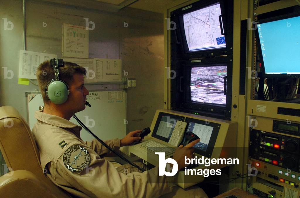 An Air Force officer maneuvers an unmanned Predator reconnaissance airplane over Iraq by remote control at Balad Air Base Iraq. July 2 2004