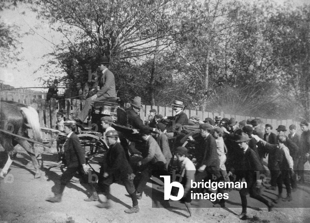 John Mitchell's horse-drawn carriage, arriving in a coal town during the Anthracite Coal Strike of 1902. Mitchell, President of the United Mine Workers of America, was surrounded by a crowd of boys. 1902
