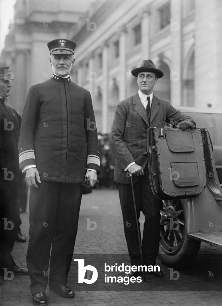 Franklin Roosevelt, with Adm. William Sims, WW1 head of US Navy in Europe. 1919. FDR, then Asst. Navy Secretary, holds a car door for Sims who publicly attacking the Navy Department's WW1 naval strategy, tactics, policy, and administration