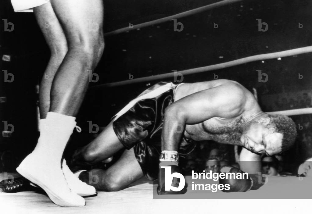 Archie Moore on the canvas in the fourth round of his fight with 20 year old Cassius Clay. Nov. 15, 1962. It was one of three knockdowns that spelled the 48 year old Moore's defeat and Clay's 16th consecutive professional victory. Clay (a.k.a. Muhammed Ali) predicted he would stop Moore in four rounds, and he knocked Moore down three times in the fourth round