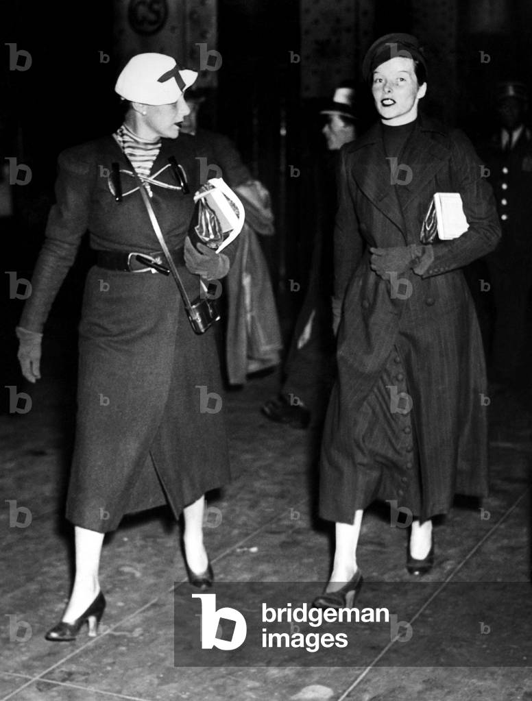 Katharine Hepburn (r) and her secretary Laura Harding (l), arrive at Penn Station, after she obtained a divorce from Ludlow Smith in Mexico. New York, New York, May 3, 1934.