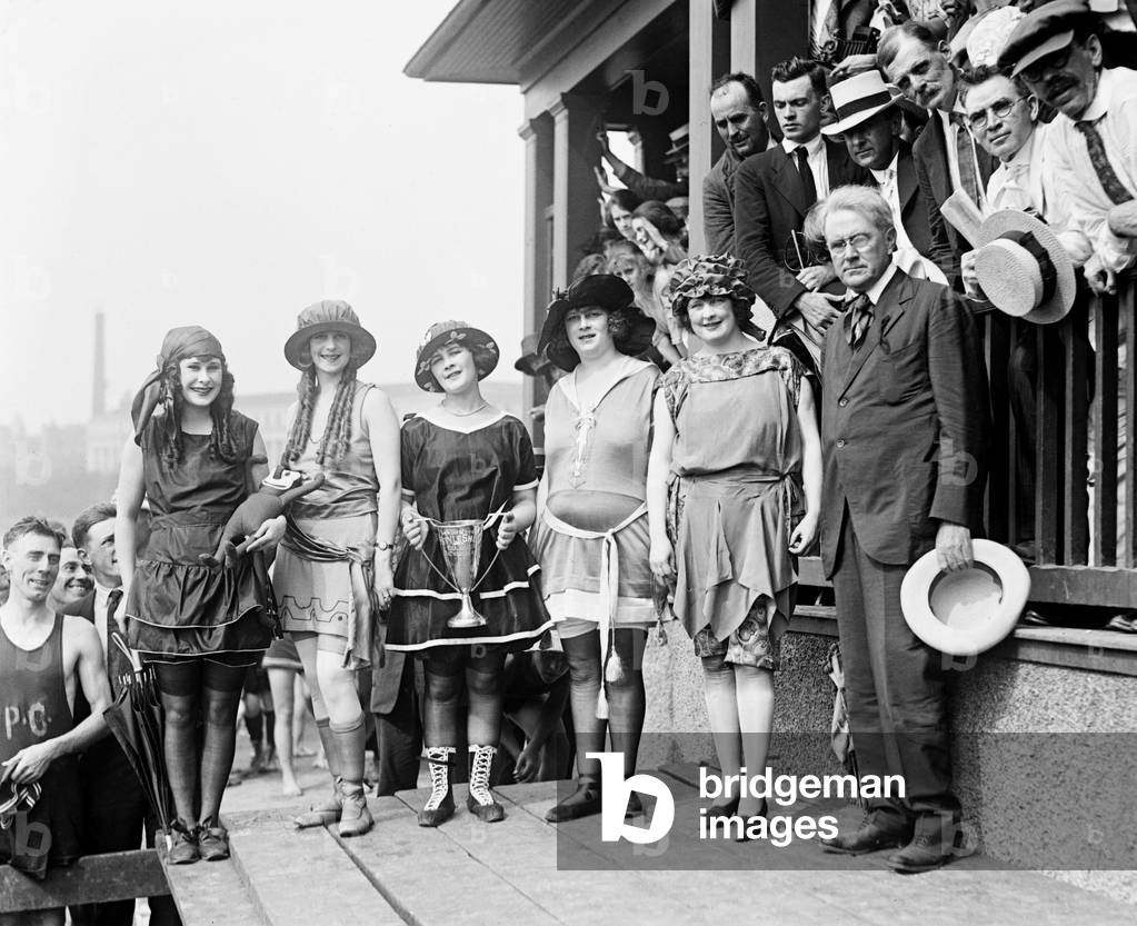 1921 beauty contestants at Washington, D.C. beach wear soon to be out of fashion bathing suits with shoes and stockings