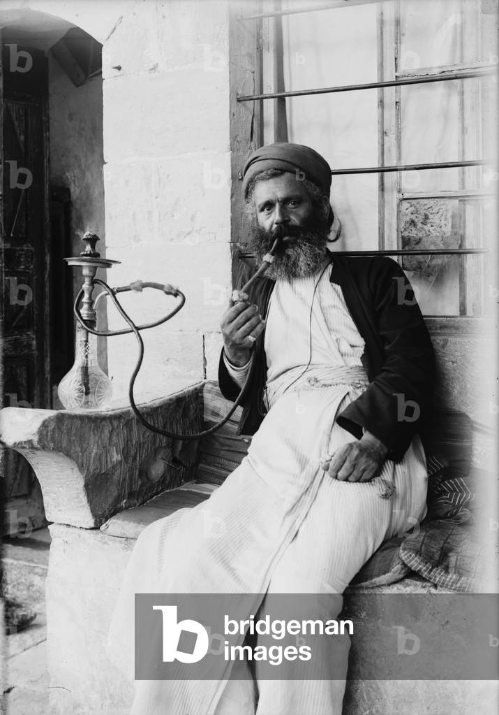 The Samaritans of Nablus (Shechhem). A Samaritan smoking the narghileh, photograph, 1900-1920