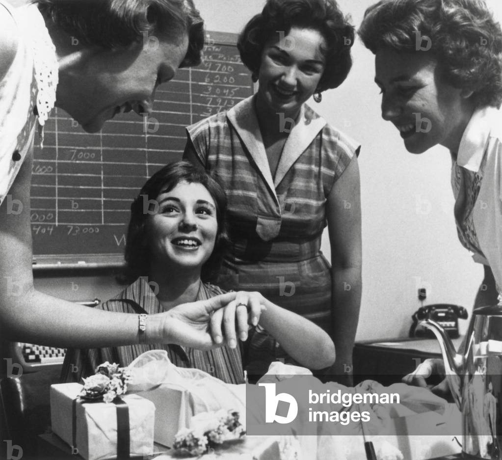 Young working women at an office party for an engaged co-worker. c. 1960