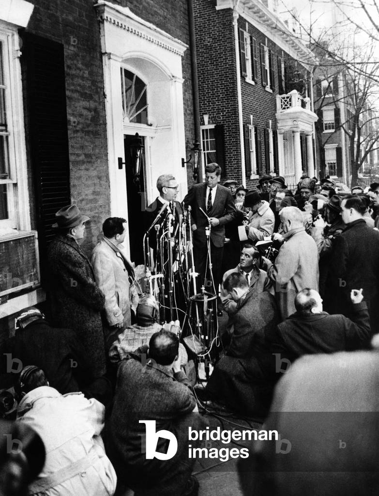 Mob scene outside President-elect John Kennedy's Georgetown home. Surrounded by microphones, cameras, and reporters, JFK announces his appointment of Arthur Goldberg as Secretary of Labor. Dec. 21, 1960