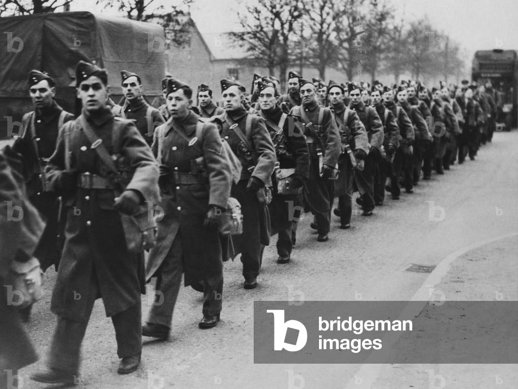 Canadian soldiers marching on a road in England in 1940, in the first year of World War 2