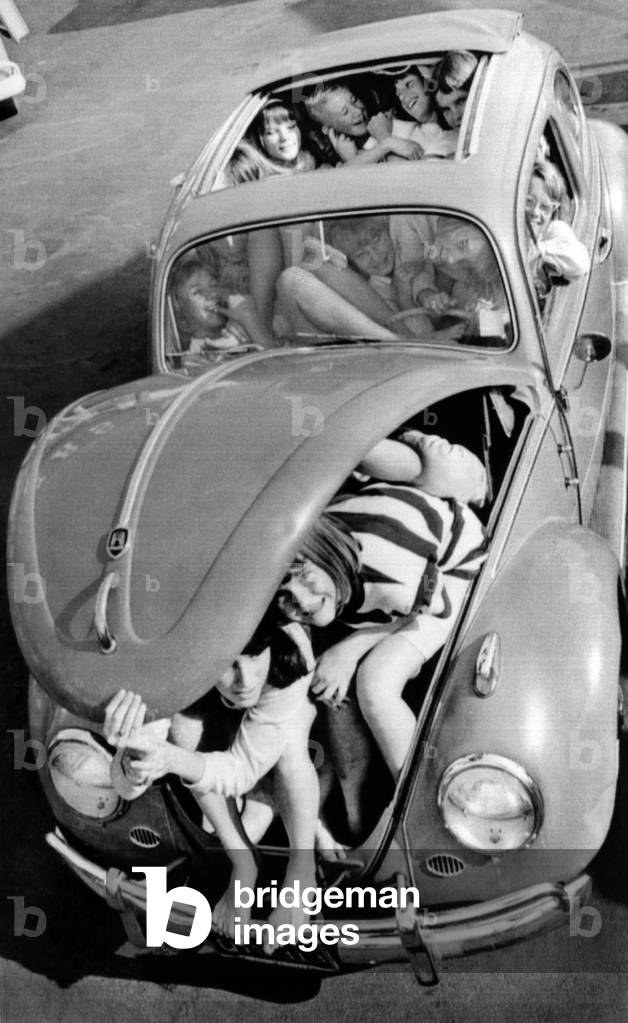 31 teenagers stuffed into a Volkswagen Beetle. Ladera Vista Junior High School students succeeded in setting a new record. Buena Park, California. Dec. 5, 1964