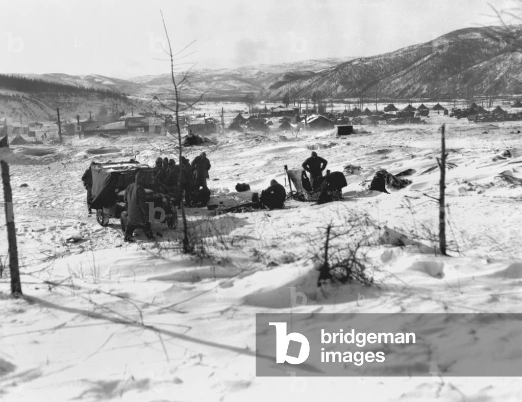 Marines seek shelter from the cold in and around vehicles at a post in Kotori during the Dec. 1950 withdrawal form the Chosin Reservoir. Korean War, 1950-53