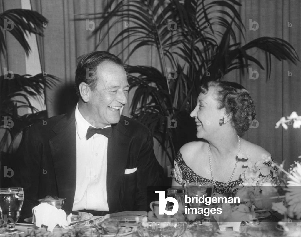 First Lady Mamie Eisenhower and actor John Wayne at political dinner. June 8, 1959.