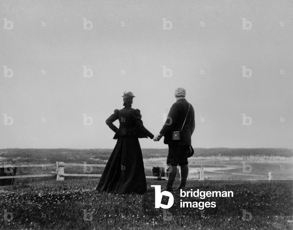 Alexander Graham Bell and Mabel Hubbard Bell hold hands and look toward the sea from Sable Island, Canada in 1898. Mable lost her hearing from scarlet fever at age five, and met Bell when she was his 15 year old student. They married five years later