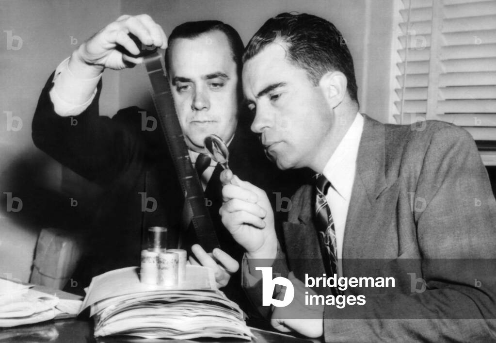Rep. Richard Nixon and Robert Stripling (HUAC investigator) examining microfilm of the 'Pumpkin papers, Dec. 6, 1948