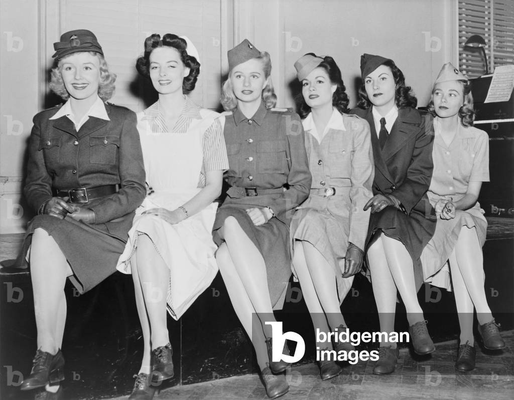 Uniforms of the American Women's Voluntary Services (AWVS), 1942. AWVS organized and trained women to serve as ambulance drivers, selling war bonds sellers, aircraft spotters, fires fighters, truck drivers, and canteen workers. World War 2