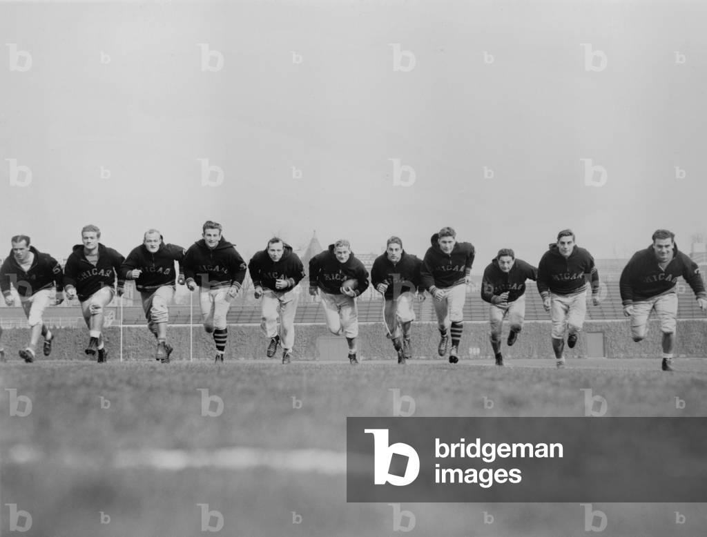 Chicago Bears' backfield charge downfield during practice session, 1941. Pictured are: Ray McLean, Young Bussey, Bill Osmanski, Hugh Gallarneau, Bob Snyder, George McAfee, Bob Swisher, Harry Clark, Sid Luckman, Ray Nolting, and Gary Famiglietti