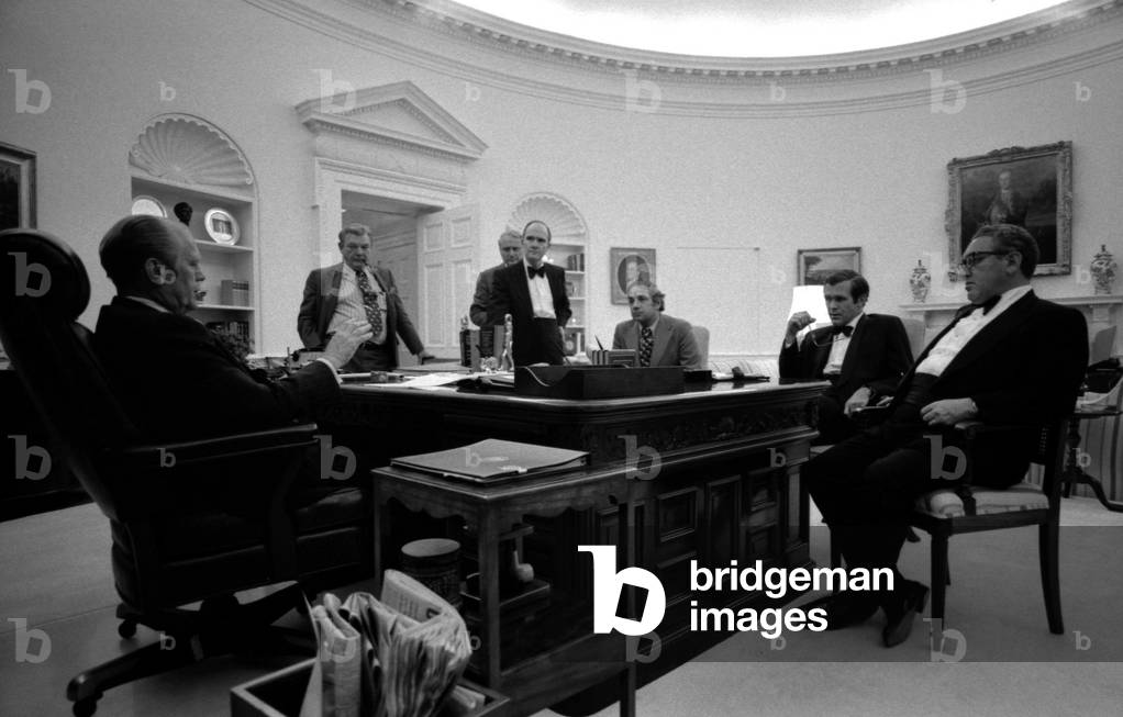 President Ford and his inner circle some still in tuxedoes work late into the night during the recapture of the S.S. Mayaguez and its crew. L-R President Ford Robert Hartmann John Marsh Brent Scowcroft Ron Nessen Donald Rumsfeld Henry Kissinger. May 14 1975