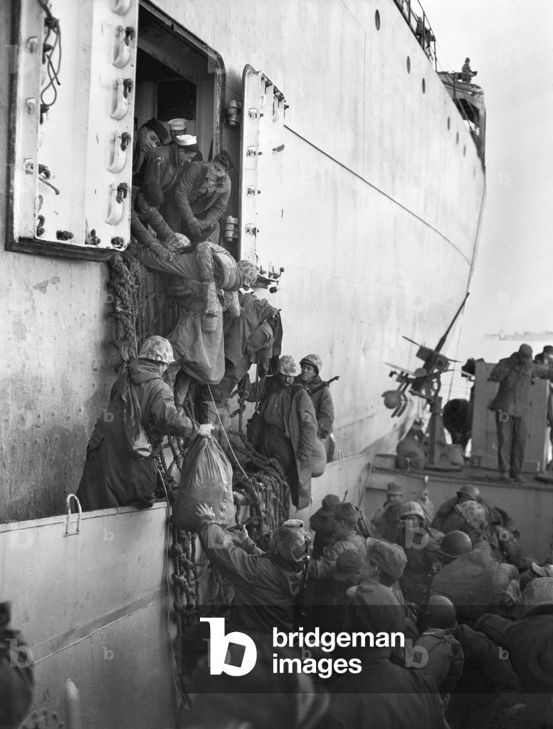 U.S. Marines board a ship for evacuation from Hungnam, North Korea, after their withdrawal from the Chosin Reservoir on Dec. 12, 1950. The UN invasion into North Korea was repulsed by the Communist Chinese Army in Nov.-Dec. 1950. Korean War, 1950-53