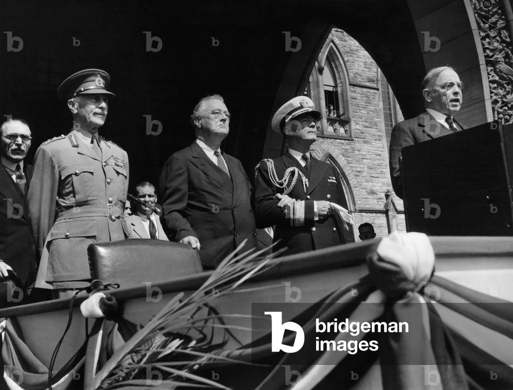 Canadian Prime Minister Mackenzie King introduces President Roosevelt to the members of the Canadian Parliament in Ottawa: The Earl of Athlone, Alexander Cambridge (front left), President Franklin D. Roosevelt (left of center), Rear Admiral Wilson Brown (second from right), Prime Minister Mackenzie King (right), August 26, 1943