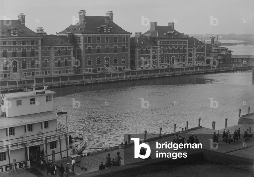 Well dressed immigrants arriving via Ferry at New York's Ellis Island. Ferries transported passengers from their Ocean going ship to the immigrant inspection station. c. 1910