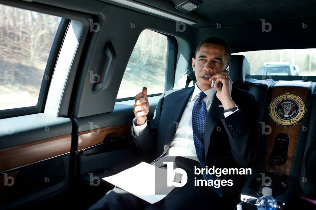 Barack Obama talks to a member of Congress while traveling in the Presidential Limousine en route to George Mason University to speak on health insurance reform. March 19 2010.,