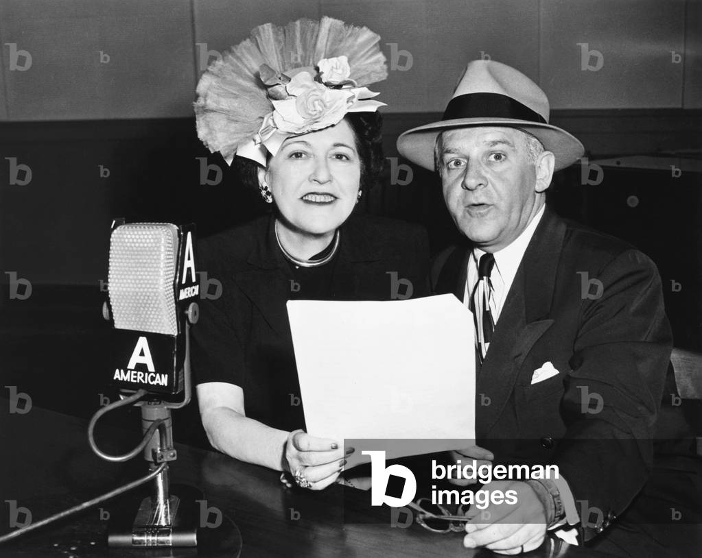 Louella Parsons and Walter Winchell, syndicated gossip columnists in print and on radio. Their NBC radio shows are scheduled on Sunday nights in August 1945. Winchell's 'Jergens' Journal' airs at 9:00 PM followed by 'The Louella Parsons Show at 9:15 PM
