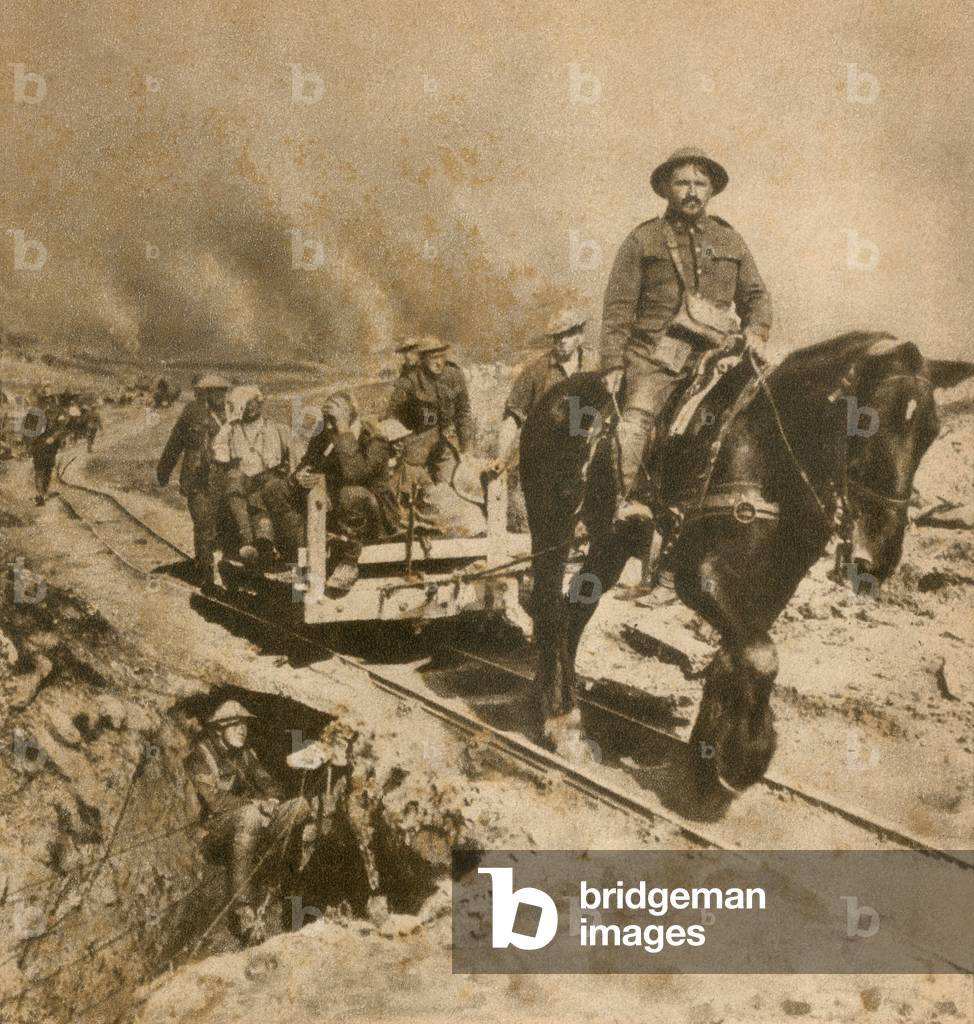 Wounded WW1 Canadian soldiers on way to rear dressing station. 1917. The horse drawn narrow gage rails were useful in the water logged battlefields of Flanders